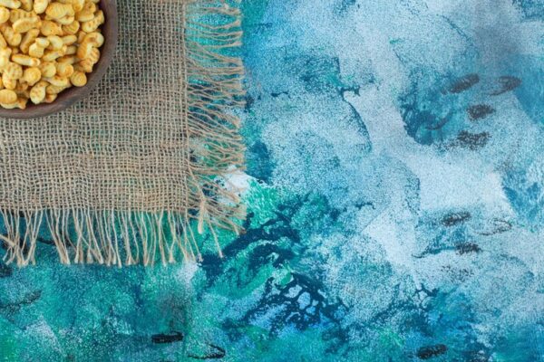 A vibrant cyan-colored fabric dyed using natural, plant-based Cyanová dye from herbal sources.