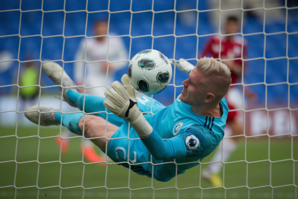 Soccer goalkeeper undergoing keeper standard test in action.